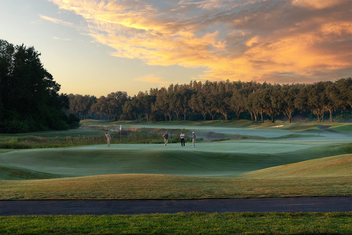 Business Marketing Commercial photography TPC Golf Club 18th hole golfers putting sunset Tampa photographer Sidney Oster