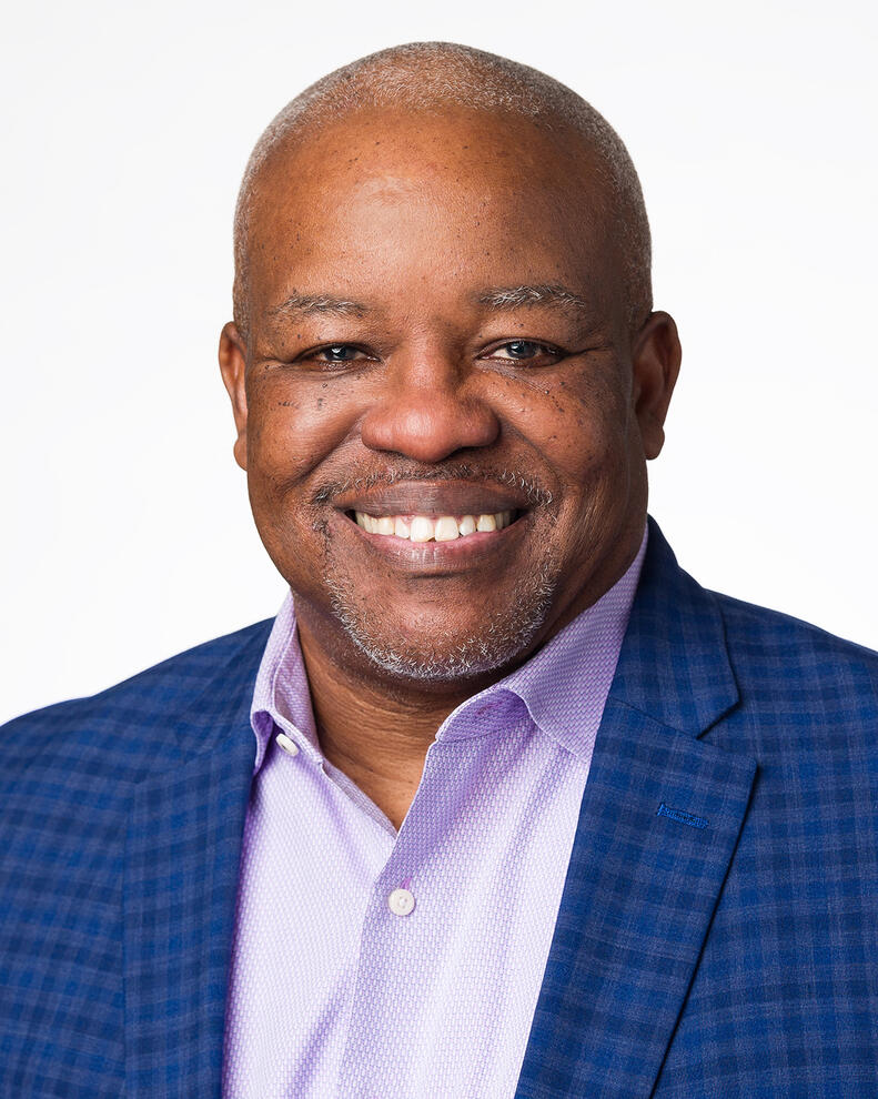 Executive Headshot Executive headshot of smiling senior black male professional in blue blazer Tampa photographer Sidney Oster