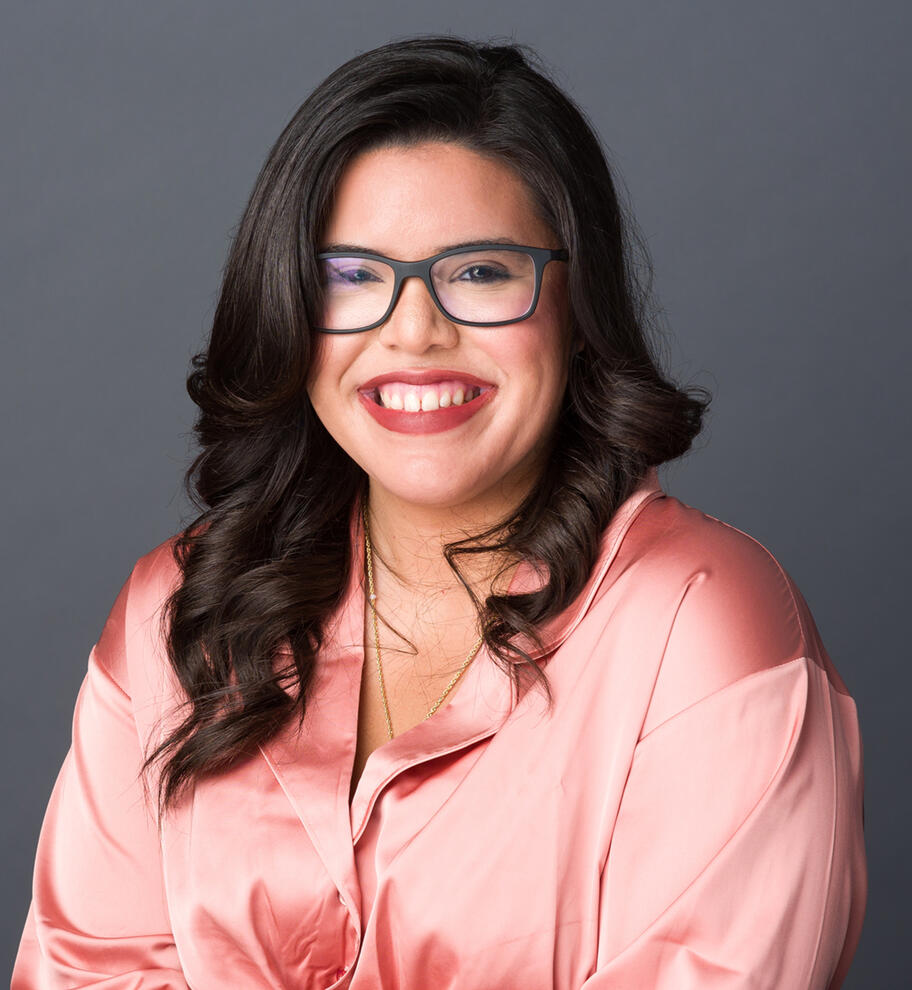 Professional Headshot Approachable professional headshot of young woman with glasses and big smile in pink silk blouse by Tampa photographer Sidney Oster
