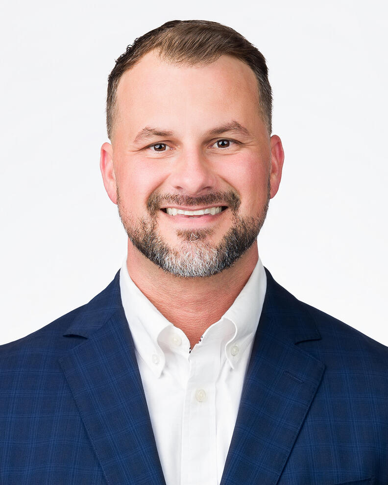 Executive Headshot Headshot portrait for male professional smiling in blue blazer by Tampa photographer Sidney Oster