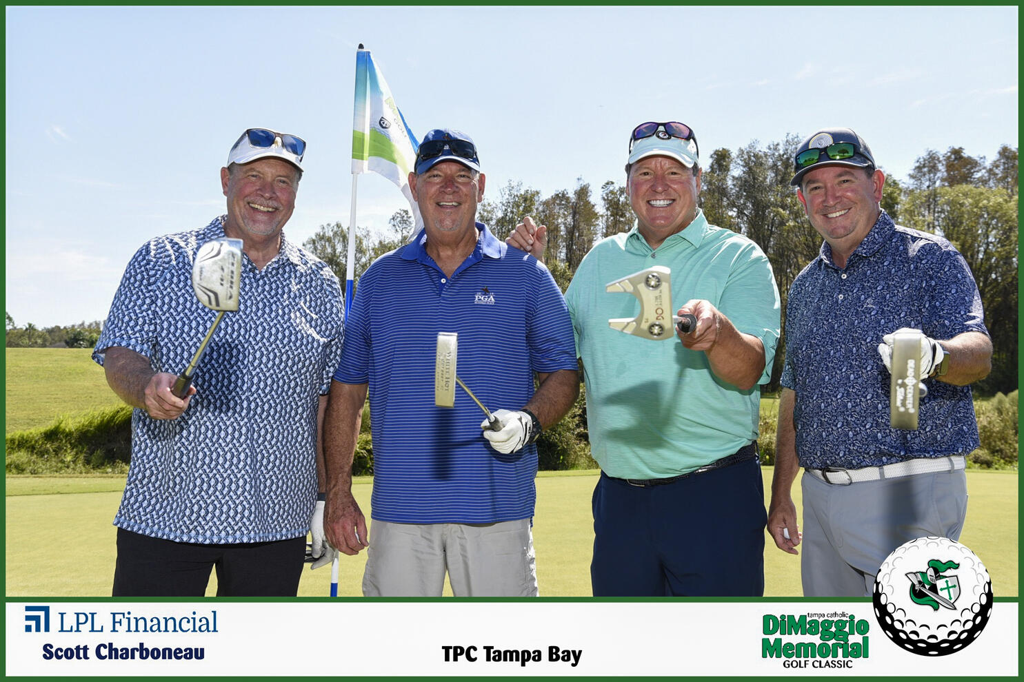 Four men holding putters golf tournament fundraiser foursome Tampa Catholic
